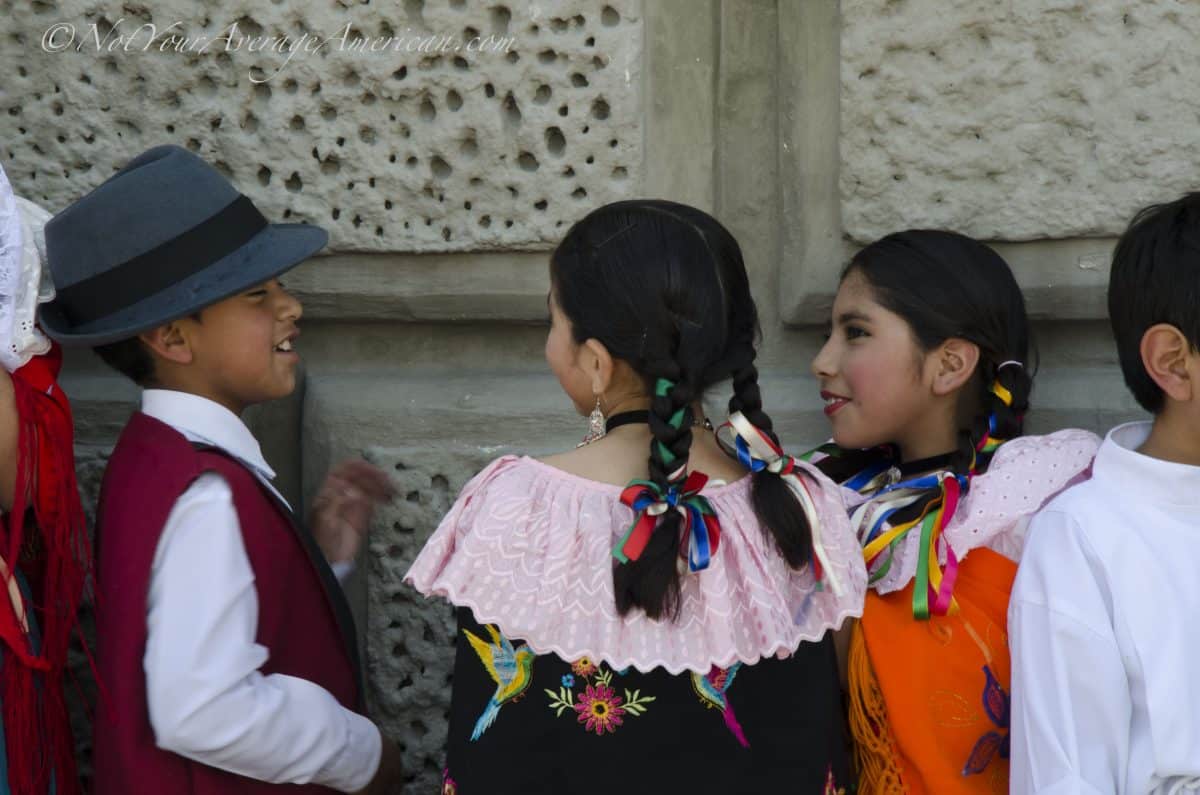 Friends talking before their turn on stage, Palm Sunday, Quito | ©Angela Drake