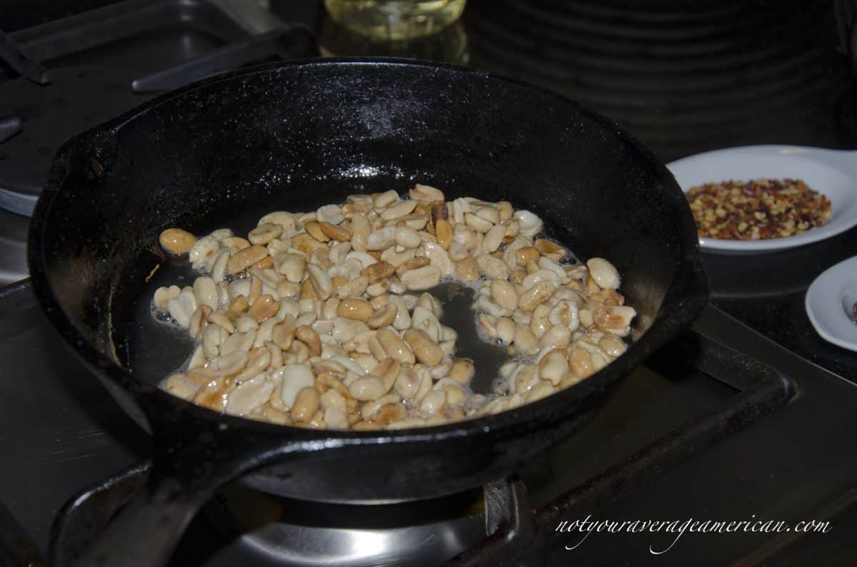 Roast fresh peanuts in about 2 teaspoons of peanut oil or a high heat, neutral flavored oil.