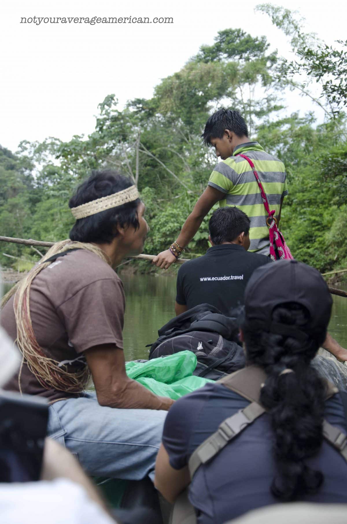 Our Huaorani guide, Bai, looks for wildlife along the river edge and our Quito guide, Cristina, translates Bai's finds into English. | ©Angela Drake