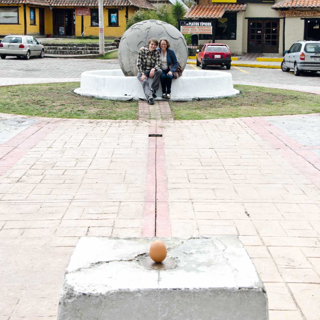 Posing with a Balanced Egg at the authentic Mitad del Mundo; Buena Esperanza, Cayambe, Ecuador | ©Angela Drake