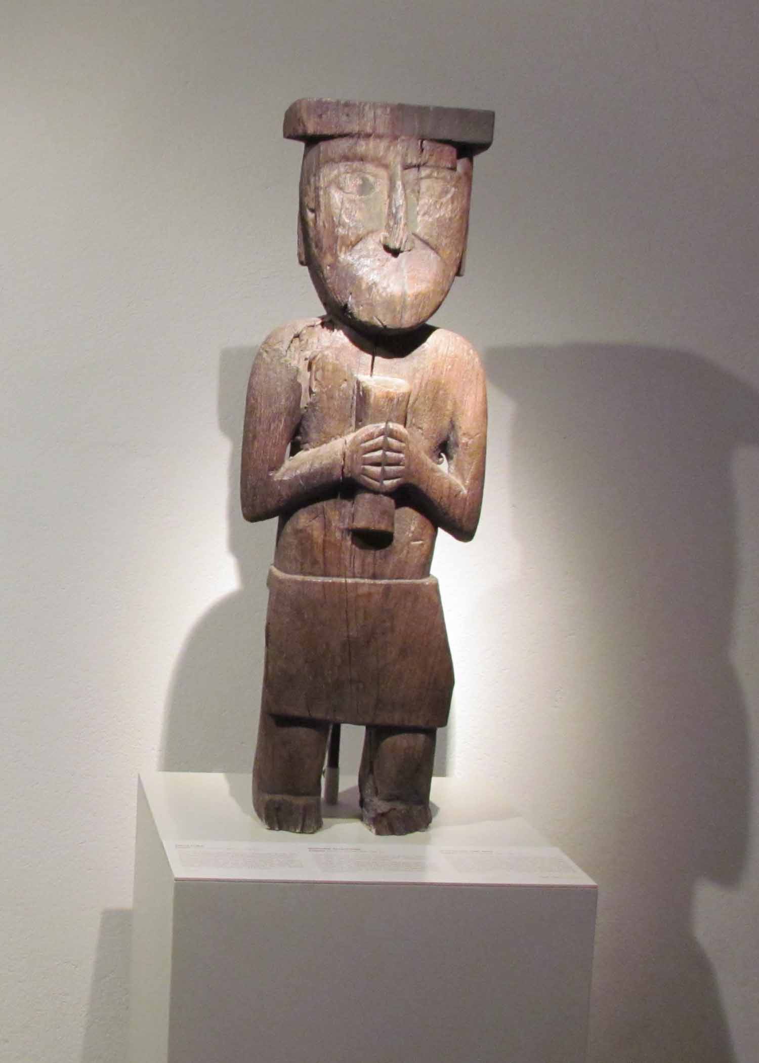 A wood carved figure on display at the Pre-Colombian Art Museum, Cusco, Peru | ©Angela Drake