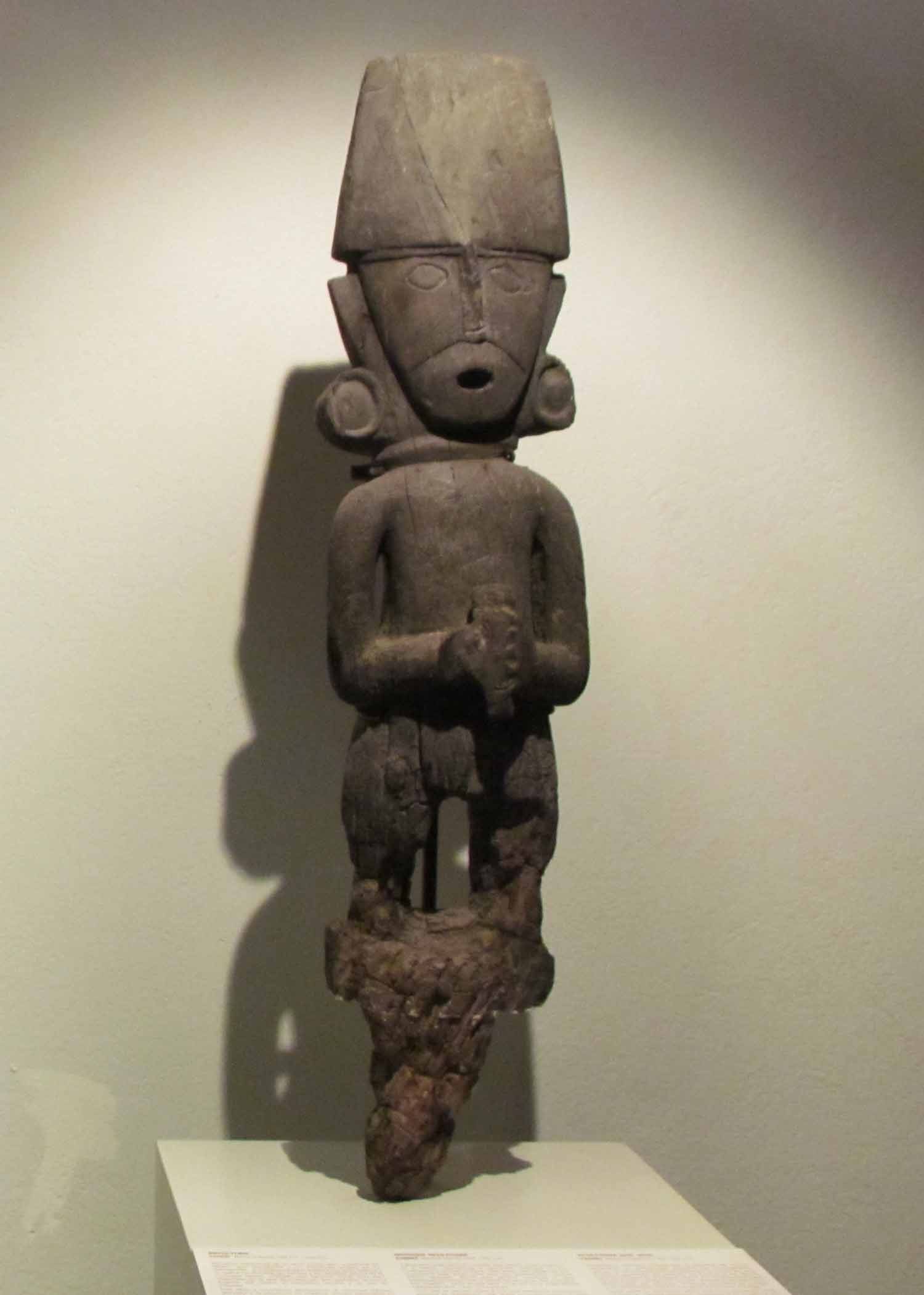 A wood carved figure on display at the Pre-Colombian Art Museum, Cusco, Peru | ©Angela Drake