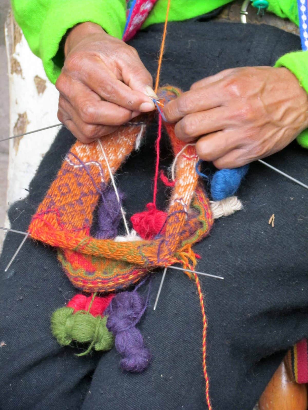 Knitting a traditional woolen hat; The Center for Traditional Textiles of Cusco, Peru | ©Angela Drake