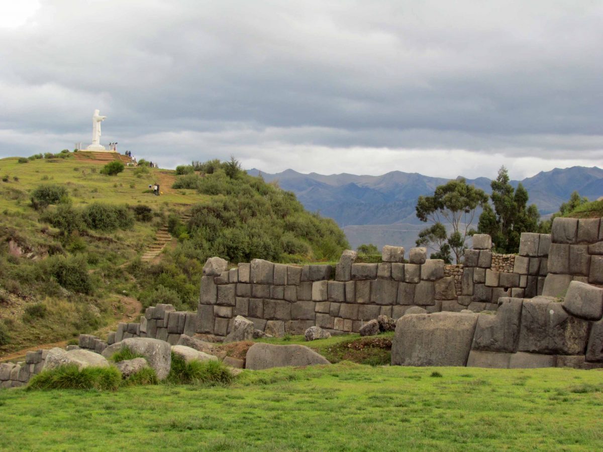 Saqsayhuamán with statue of Jesus in the background; Cusco, Peru | ©Angela Drake