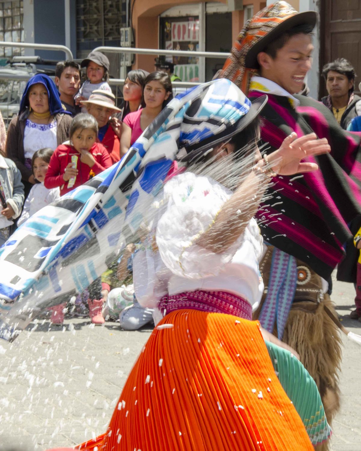 Woman runs from foam spray,Carnival in Guaranda