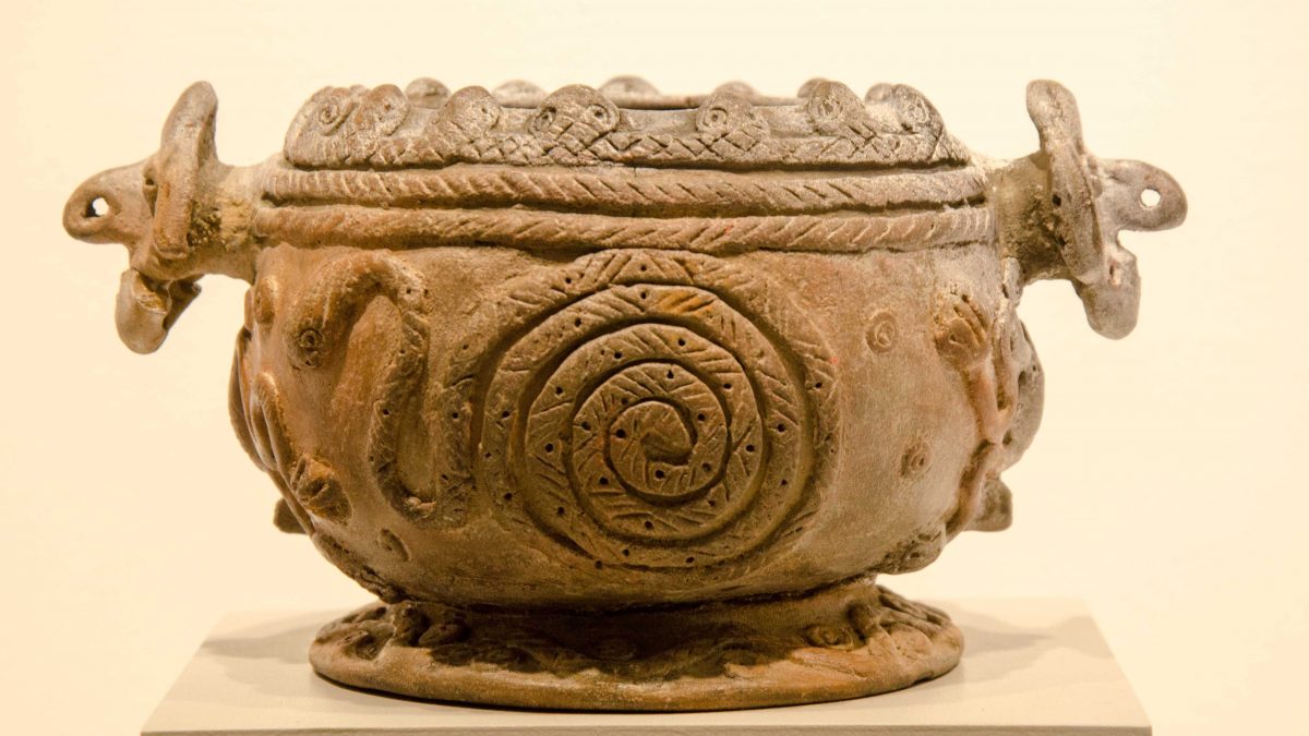 A curled snake on a pottery piece displayed at the Weilbauer Museum, La Catolica (PUCE), Quito, Ecuador