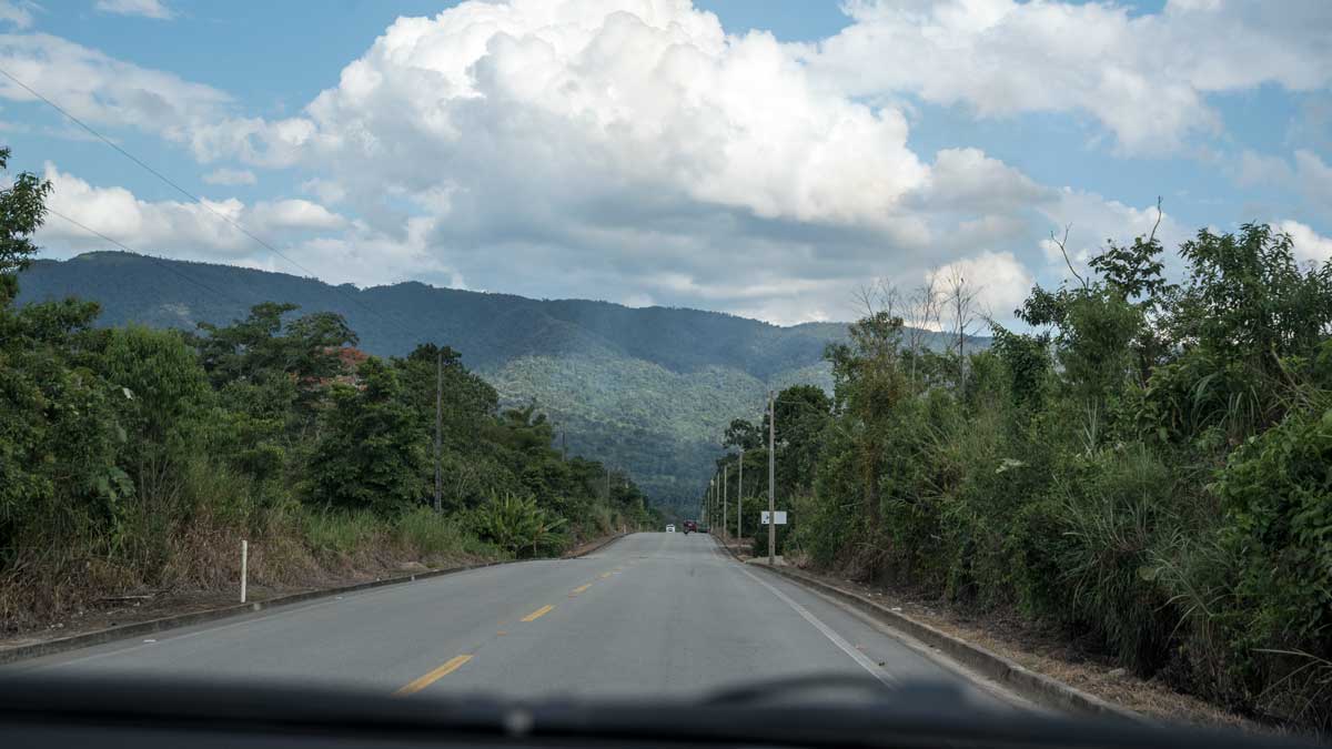 Staying connected in rural Ecuador, even on highways, can be complicated. A paved two lane road in rural Ecuador, with mountains in the distance