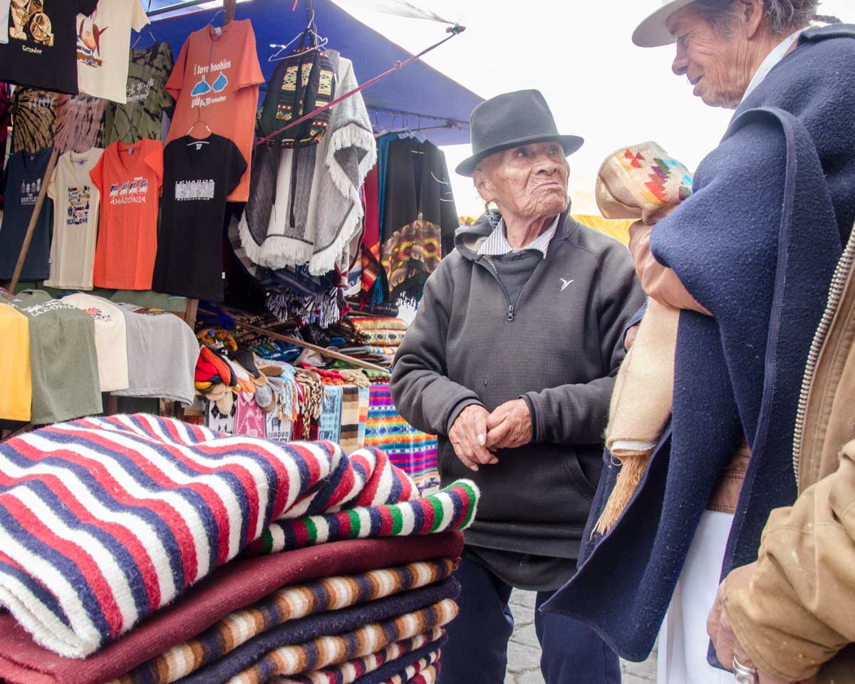 Poncho Vendor, Plaza de los Ponchos, Otavalo, Ecuador | ©Angela Drake