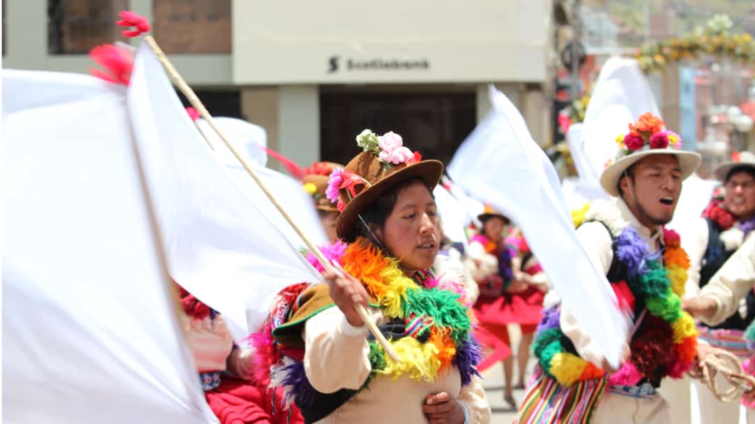 Participants of the procession bring brightly colored necklaces and rustic hats