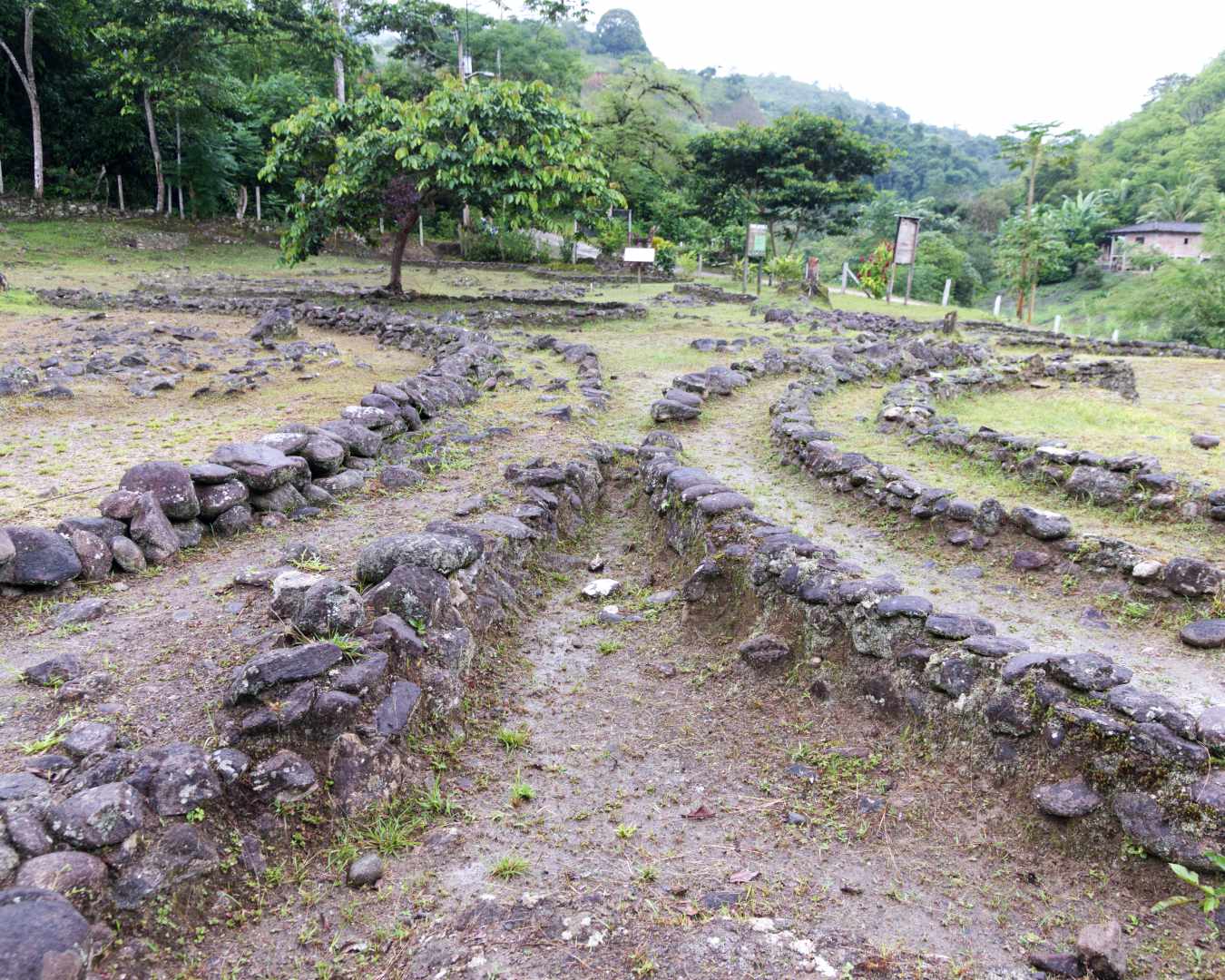 Two symmetrical arcs of stone walls touch at their closest points