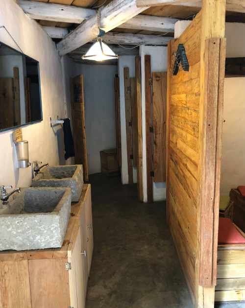 Stone sinks, Rustic wood doors leading to changing rooms