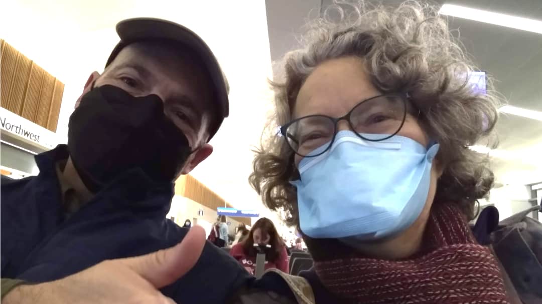 Angie is wearing a duck-billed mask. In her opinion, it is the best face mask for air travel.