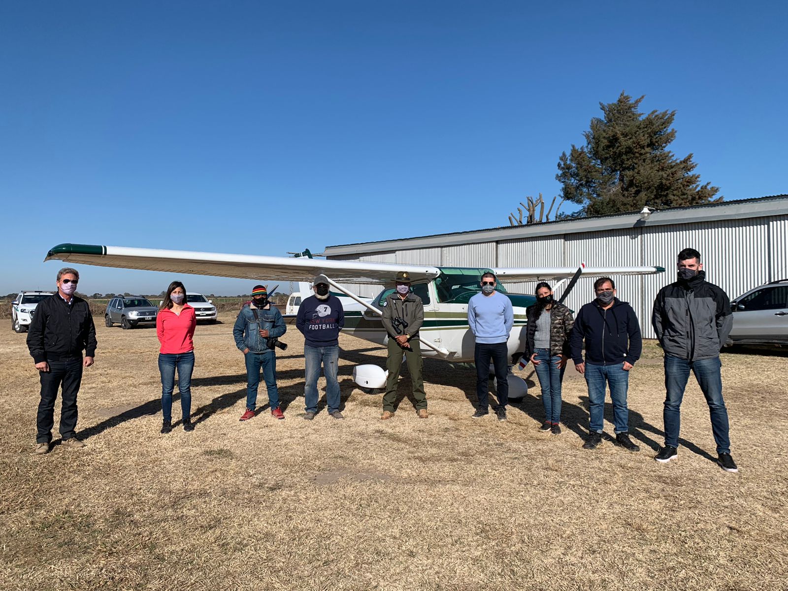 Preparing for an aerial survey of Laguna Mar Chiquita and surrounding wetlands | ©Natural International A team of eight people stand in front of a small plane