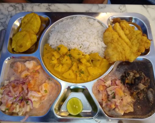 Una Bandeja from La Yapa includes four different seafood dishes, rice, and patacon