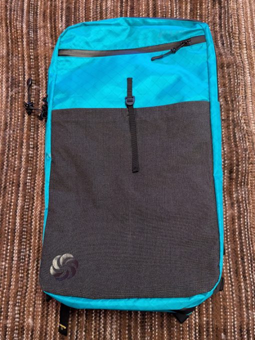 Front of the ADC Backpack shows a zipper pocket and a front pocket that you can slide a water bottle, Kindle, or other easy accessible item.