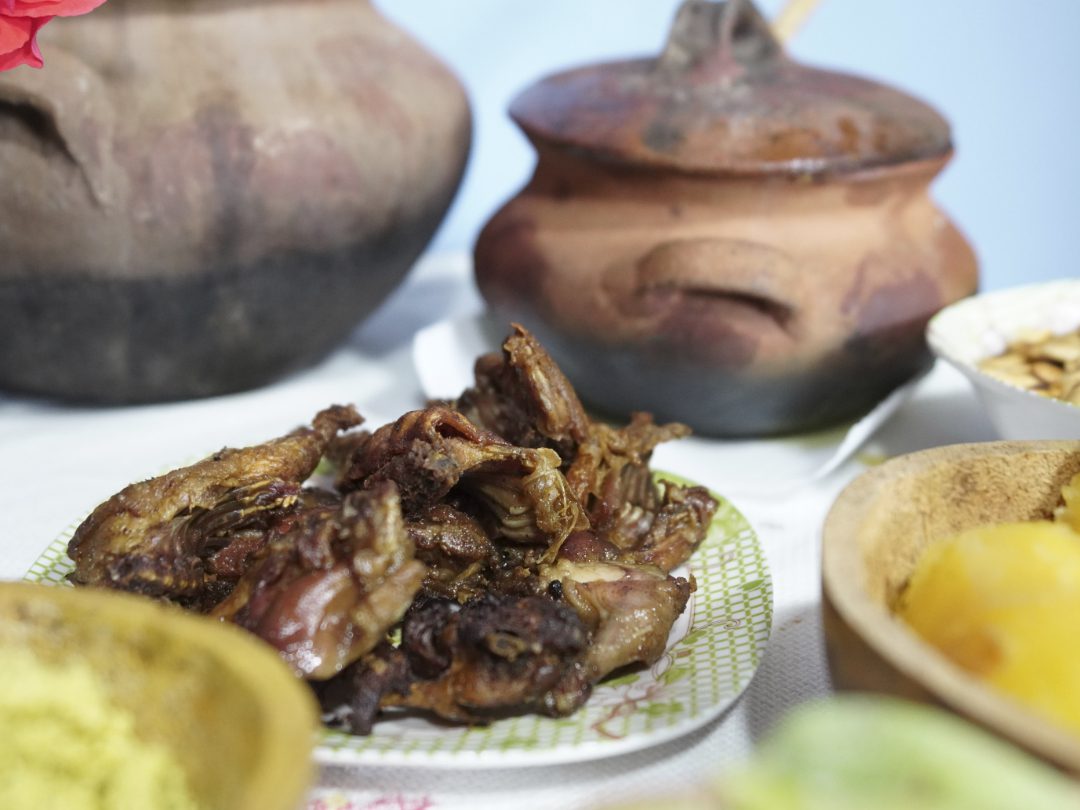 Platters of food and ceramic dishes line the table in Cuemal, Peru