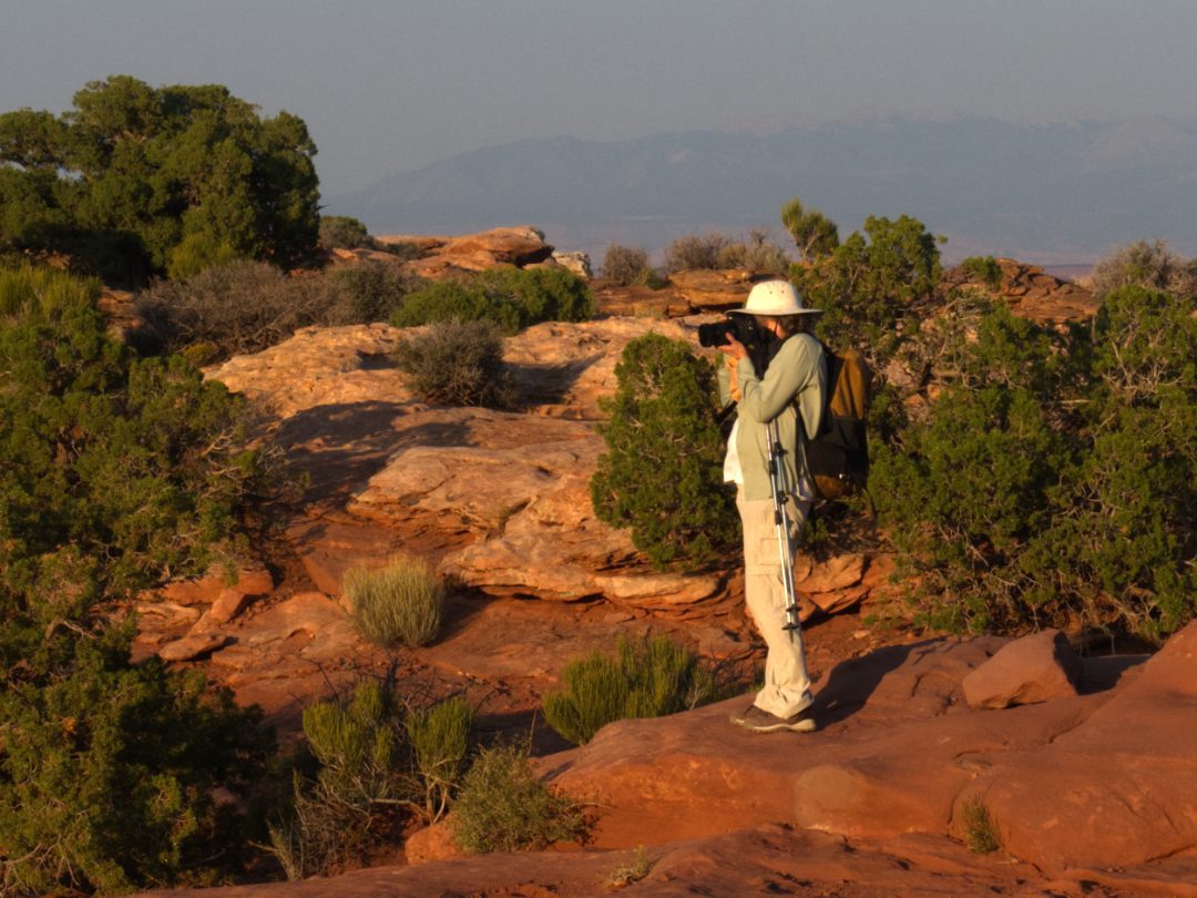 Angie at Canyonlands photographing the red rocks at Golden Hour