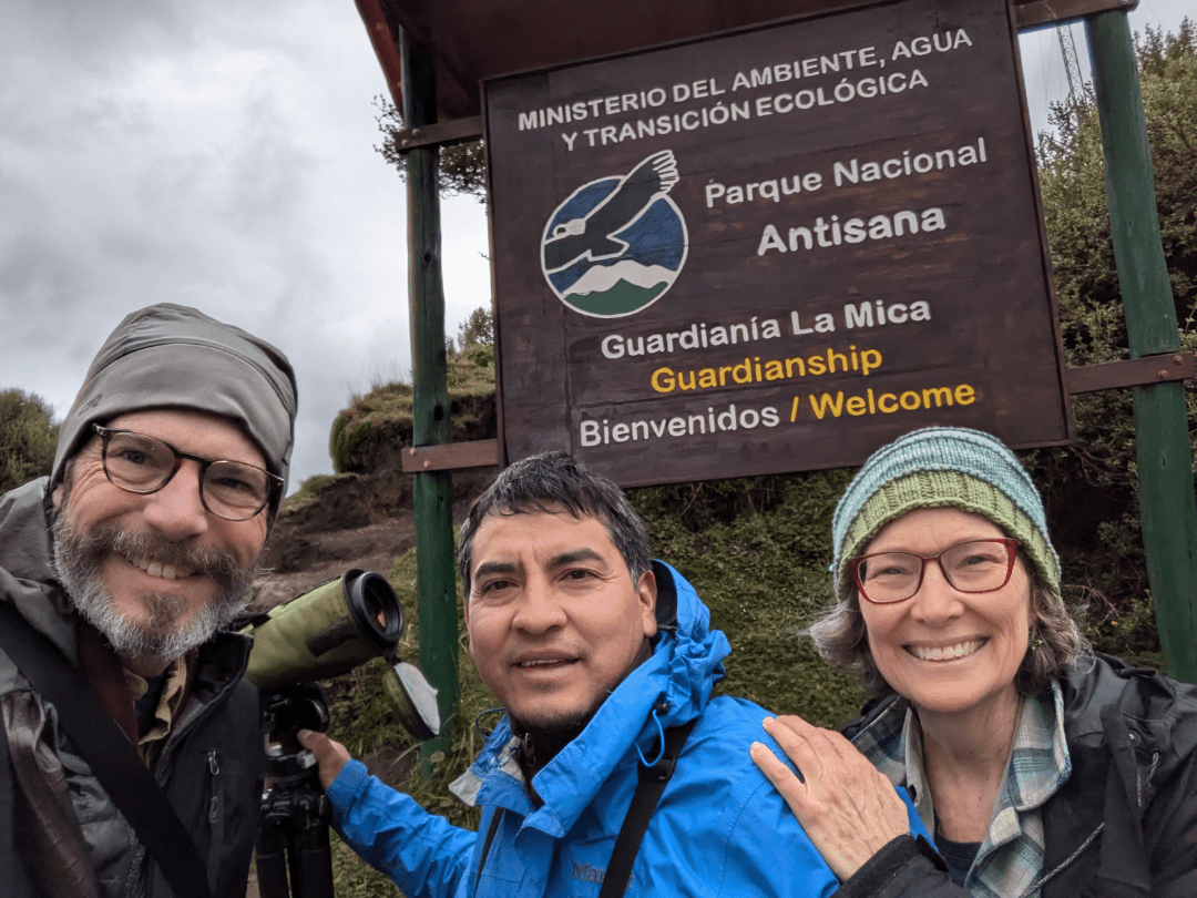 Vladimir with Scott and Angie Drake Three people stand in front of a sign for Antisana National Park
