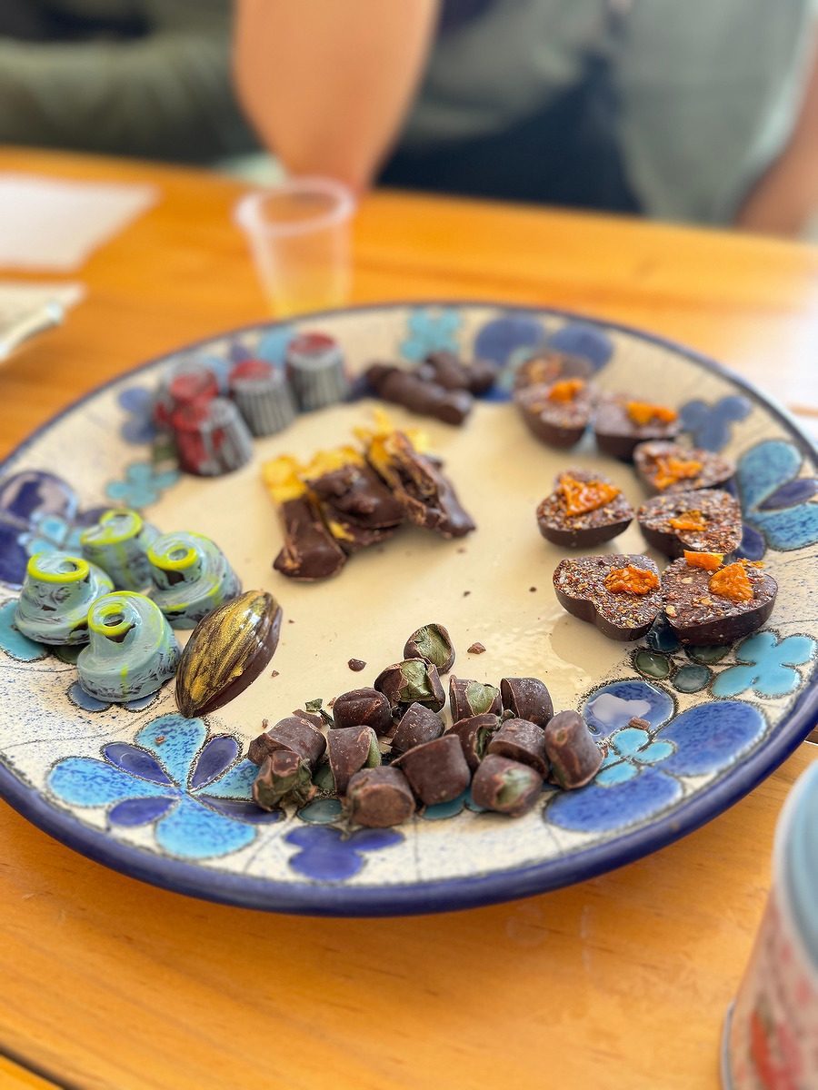 A delicious selection of chocolate candies on a pottery plate