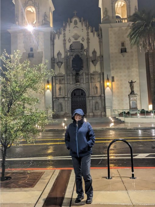 Angie standing in front of the cathedral in Tucson, Arizona wearing her Craft Sportswear Women's CORE Explore Shell Jacket while it pours with rain. Angie standing in front of the cathedral in Tucson, Arizona wearing her Craft Sportswear Women's CORE Explore Shell Jacket while it pours with rain.<br />