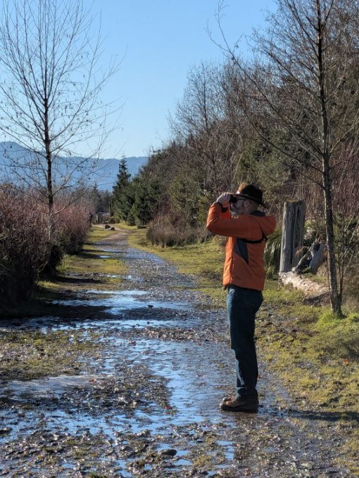 Scott wearing a Craft Sportswear Men's ADV Explore Lightweight Jacket while birdwatching on a sunny day in Oregon Scott wearing a Craft Sportswear Men's ADV Explore Lightweight Jacket while birdwatching on a sunny day in Oregon