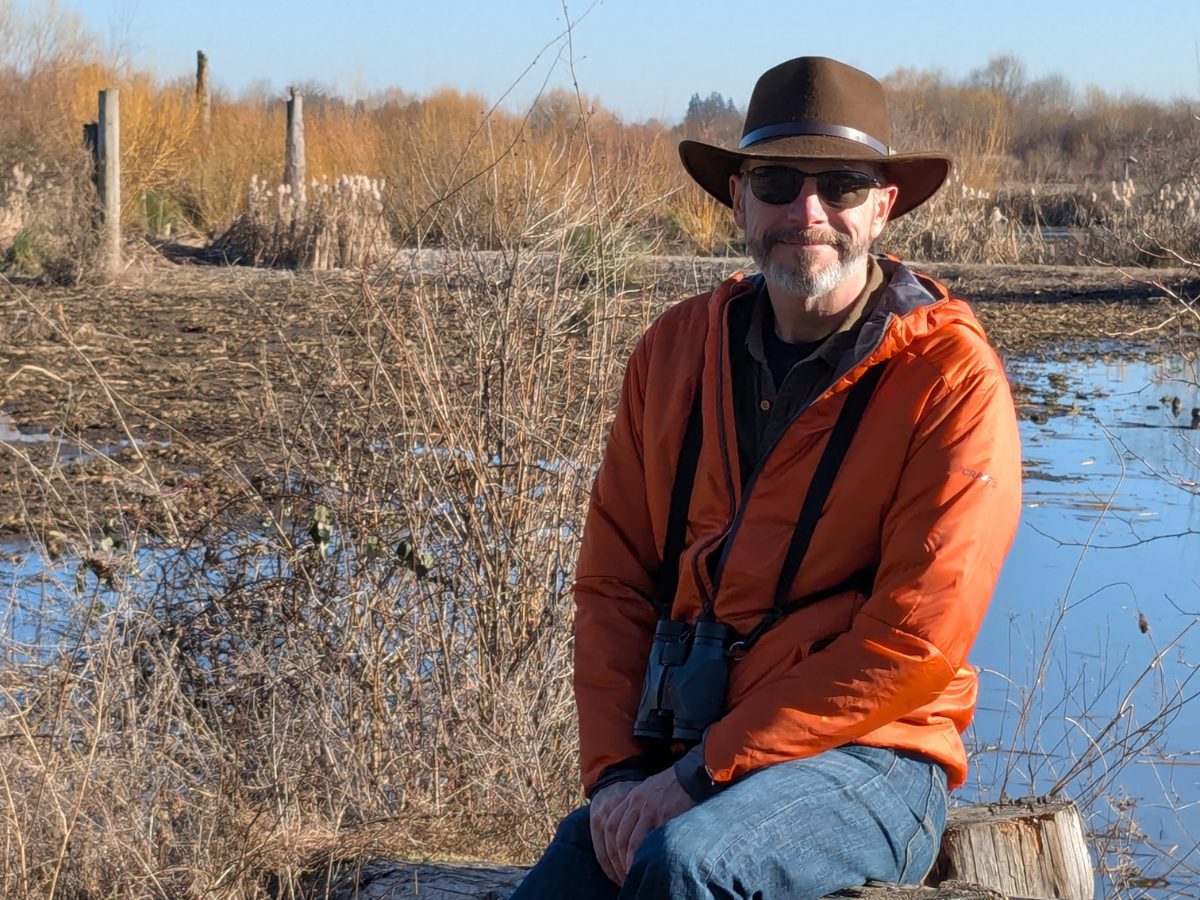 Scott wearing a Craft Sportswear Men's ADV Explore Lightweight Jacket Scott wearing a bright orange Craft Sportswear Men's ADV Explore Lightweight Jacket while birdwatching at Fernhill Wetlands in Forest Grove, Oregon