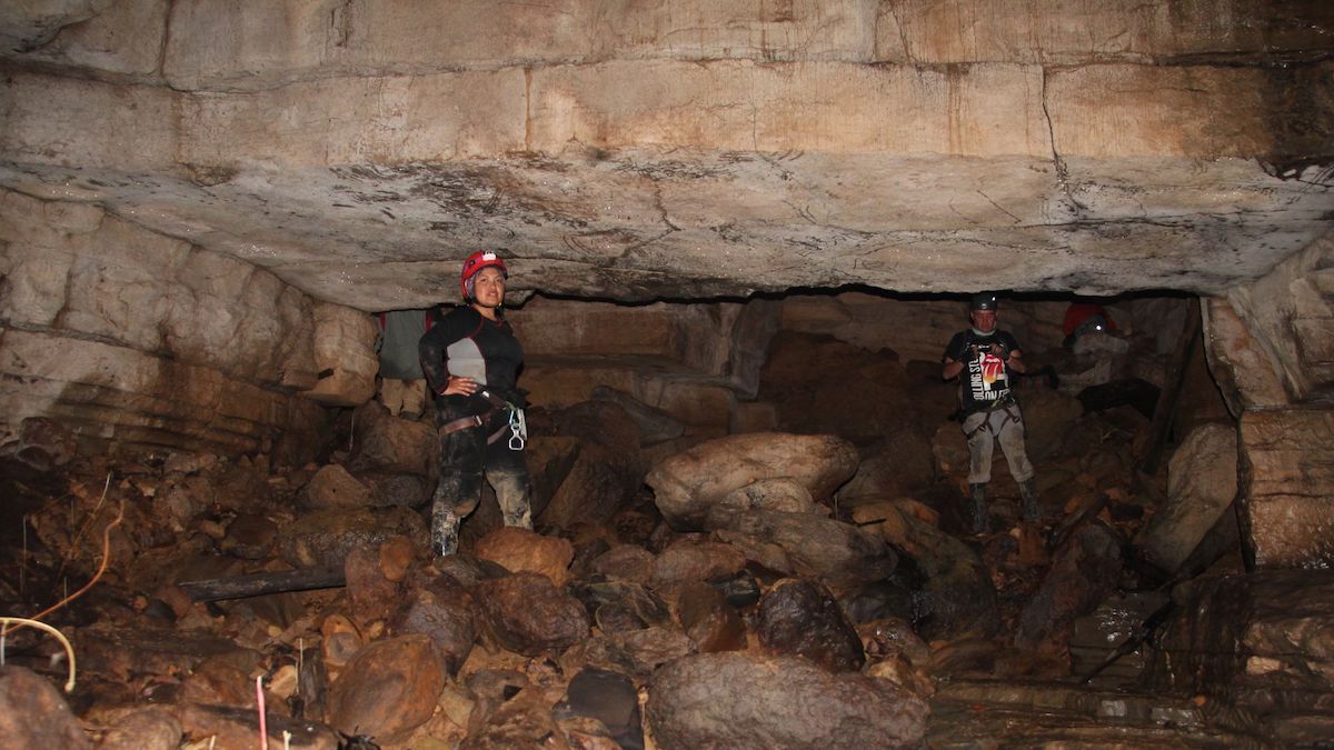 Jacki in the Cueva de los Tayos next to the rocks.