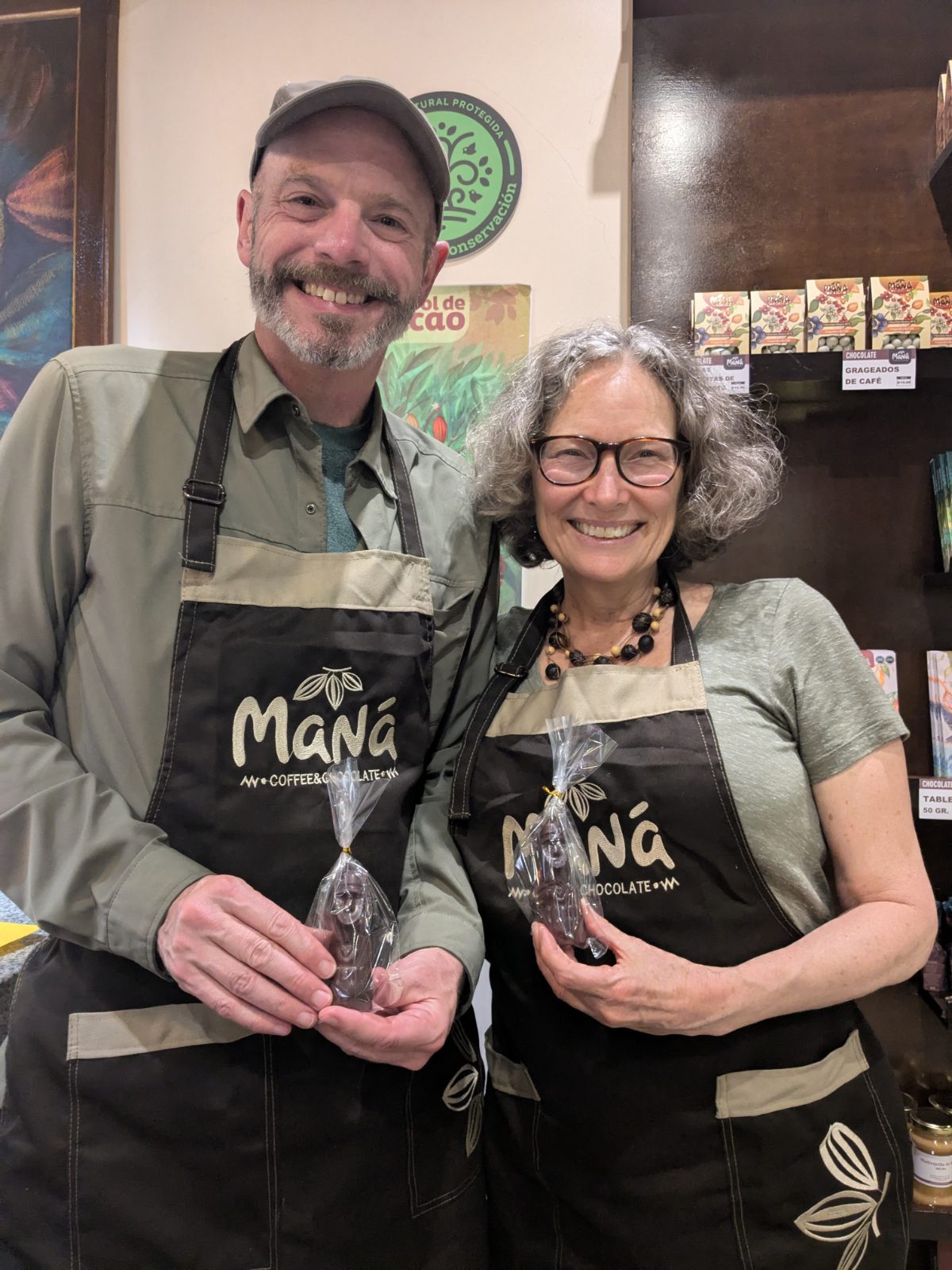 Scott and Angie with their chocolate bars Scott and Angie in their Maná Coffee and Chocolate aprons hold their newly minted chocolate bars, shaped like small Chachapoyas Sarcophagi.
