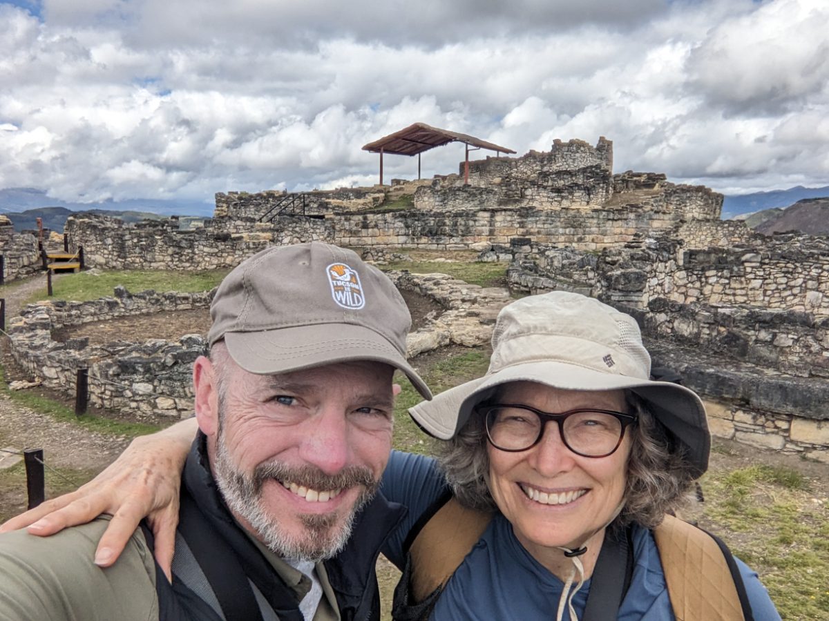 Scott and Angie smile for a selfie in front of ruins in Kuelap, Peru