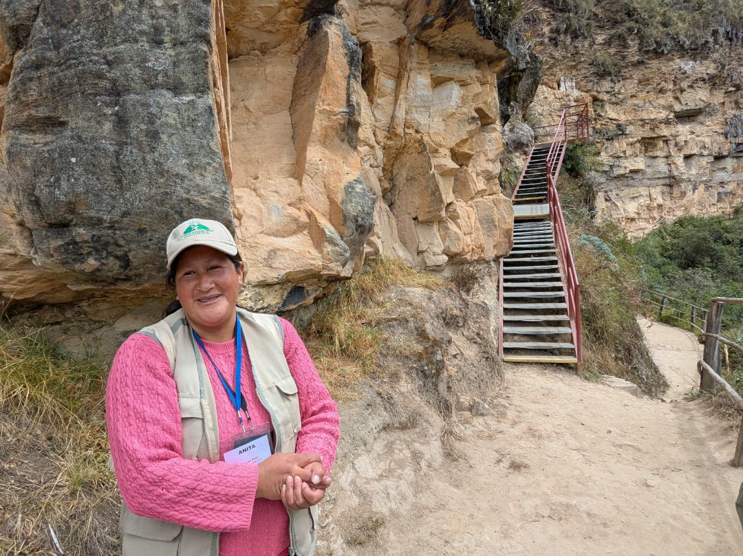 Local guide, Anita Ventura, stands before the steps to the viewing stand of the Karajia Warriors.