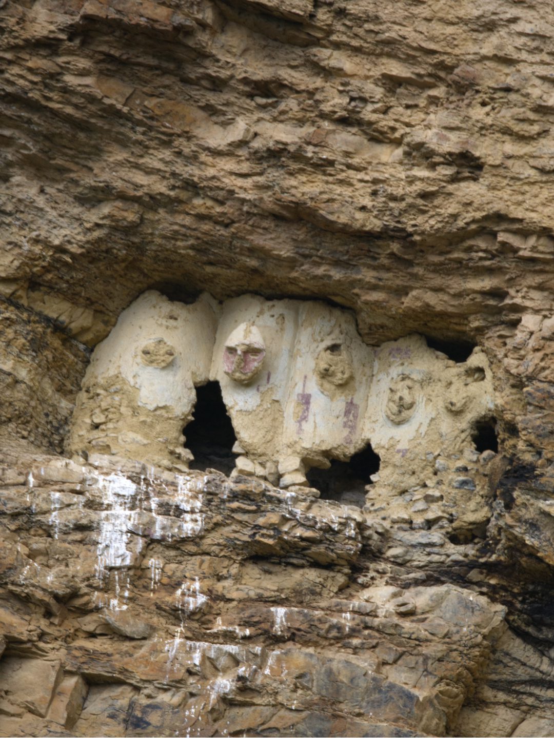Another set of sarcophagi at Karajia are hidden in a crevice and shaped more like small urns than tall figures.