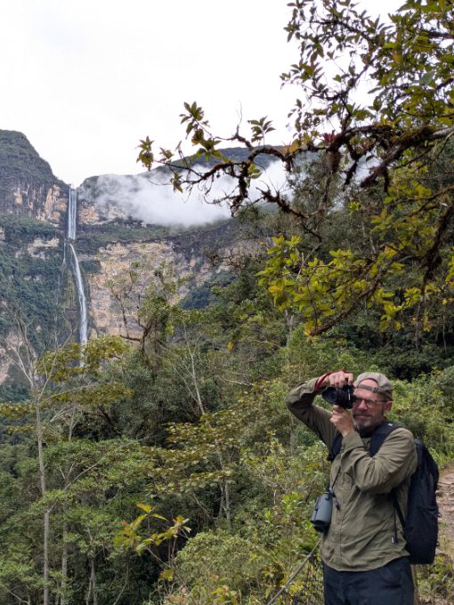 Scott taking photos while wearing Aero Jet backpack with Gocta Falls in background