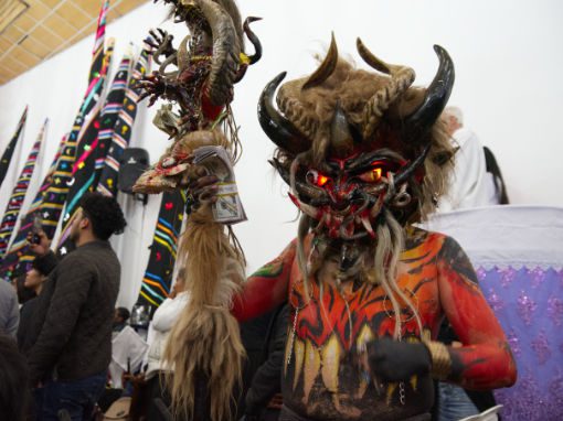 One of the devils of Alangasi, with a huge mask sprouting four curved horns, hairy face, and glowing eyes.