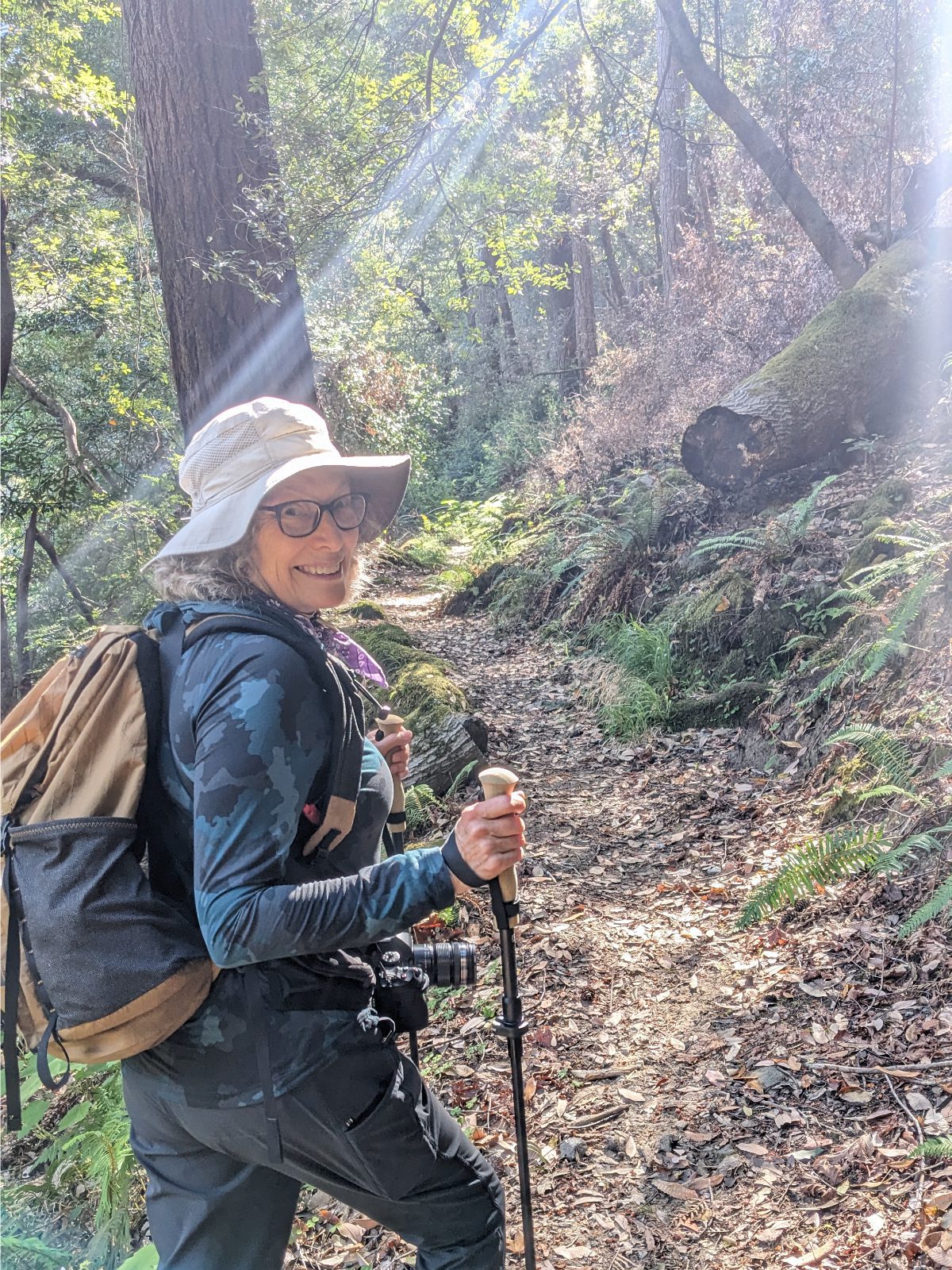 Angie dressed in full hiking gear as she takes off on a well maintained trail through the woods.