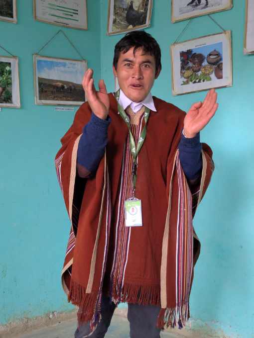 An animated Dagoberto, his hands midmovement and eyes bright as he tells the story of the founding of Cuemal.