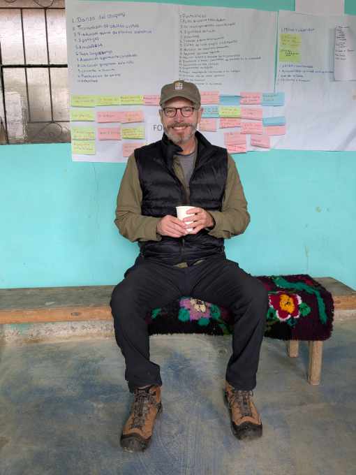 Scott sipping hot mint tea while sitting on a bench in the Cuemal Interpretive Center.